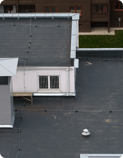 Professional flat roof installation on a commercial building in Jersey City, NJ