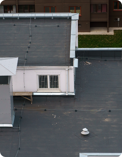 Professional flat roof installation on a commercial building in Jersey City, NJ