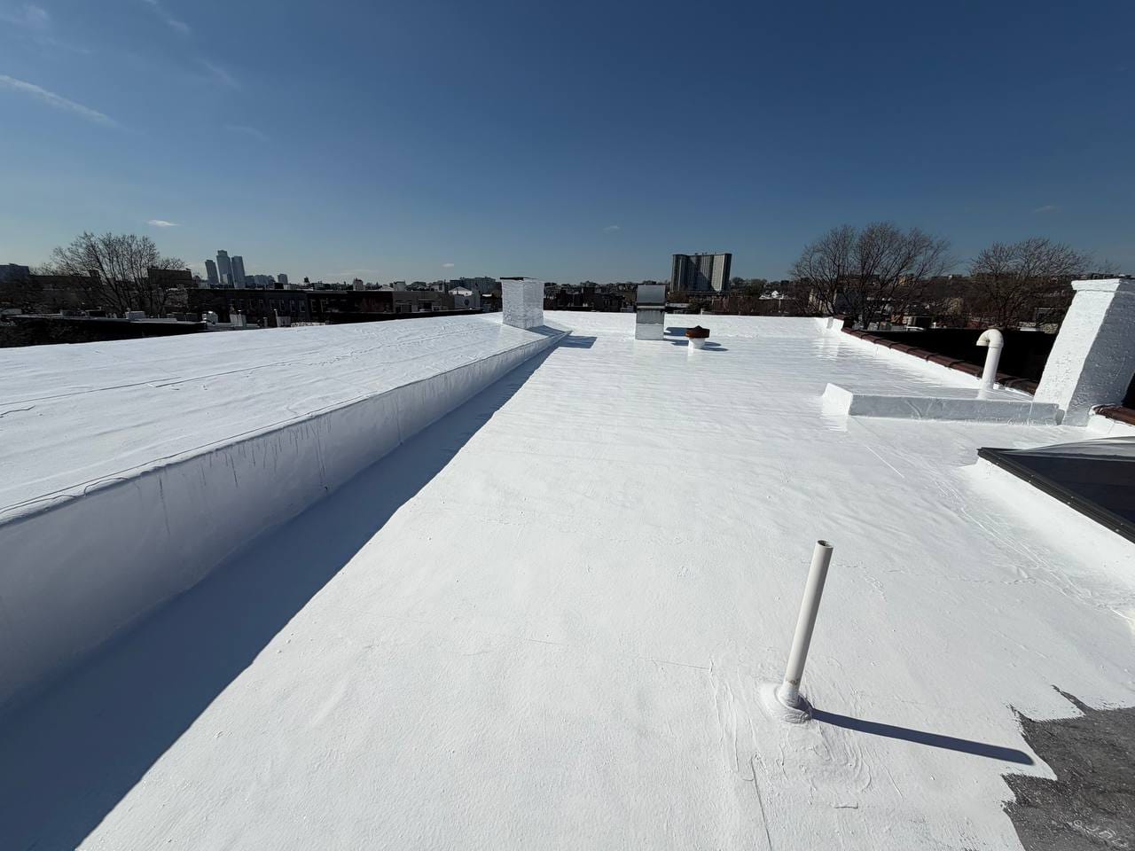 Flat roof coating application using HydroStop system in Jersey City, NJ